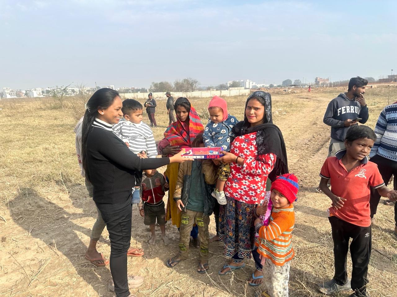 A mother and her children receiving a gift pack