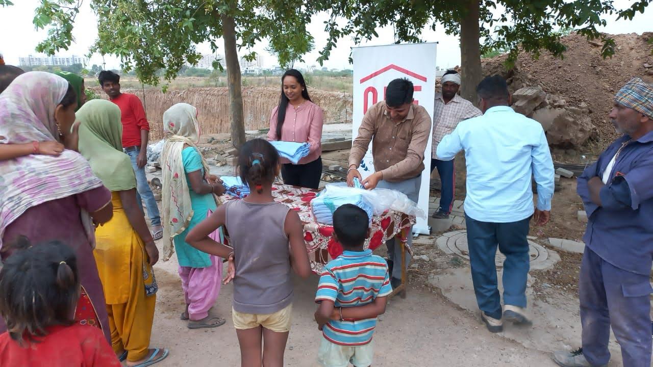 Families gathering at a ONE Group clothing distribution drive