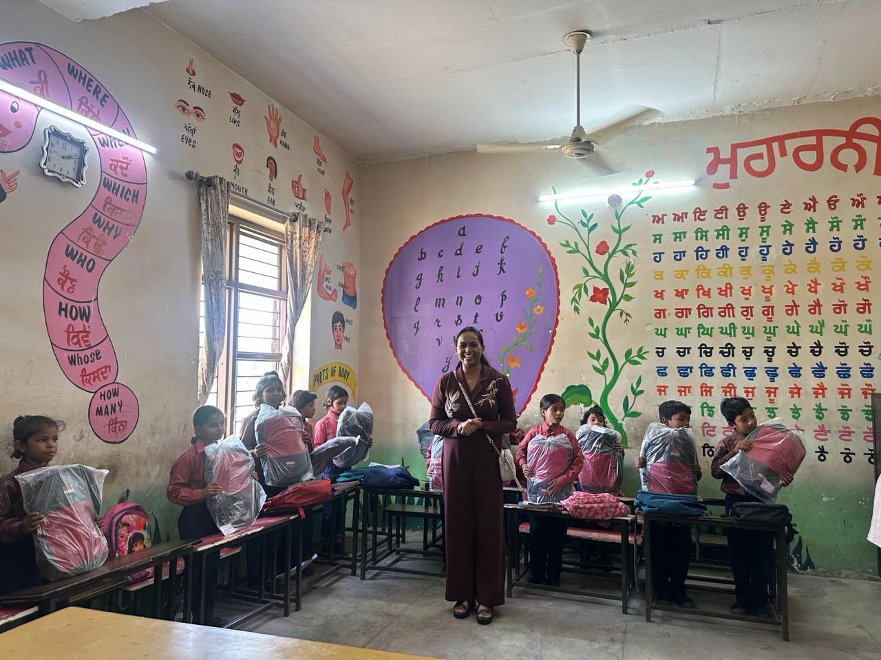 Children in a classroom with new school bags on their desks