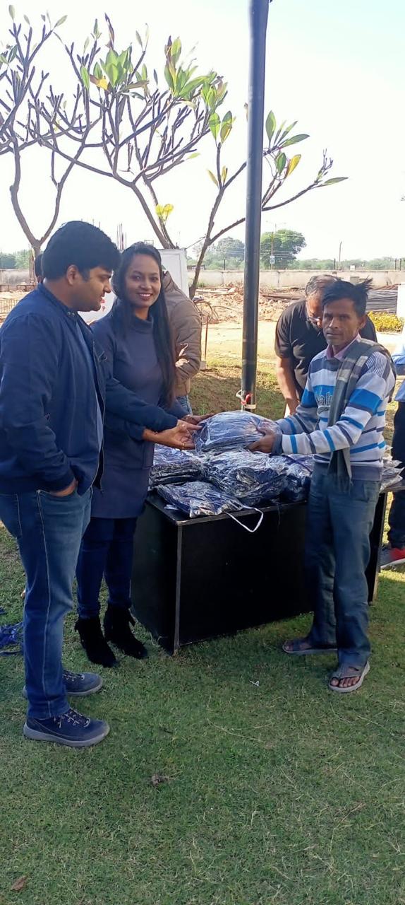 The foundation team handing clothing packs to a worker