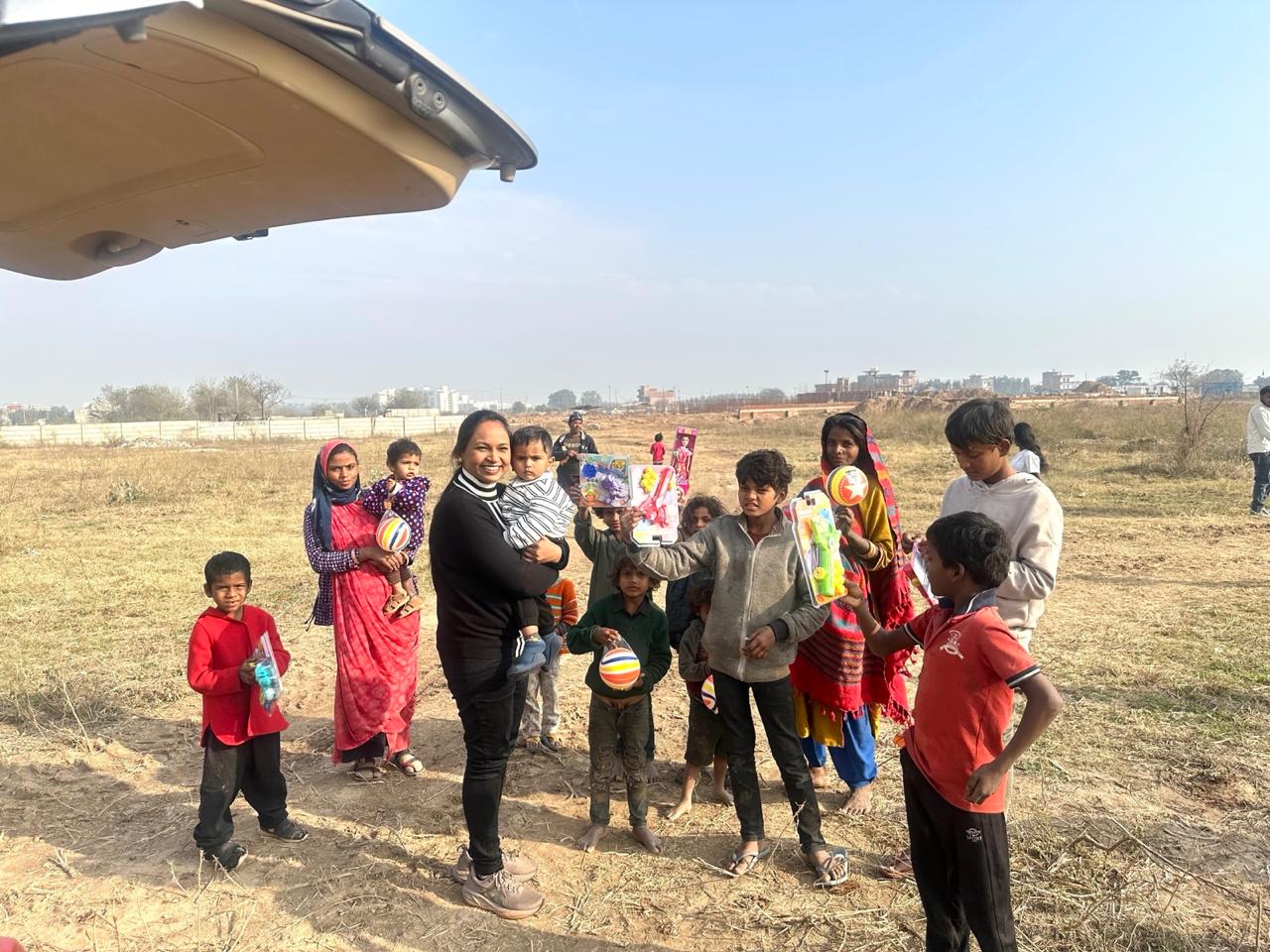 Children with new toys in an open field